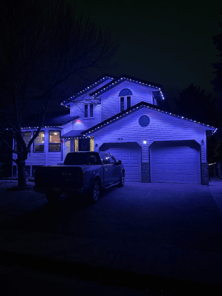 Permanent celebration lighting installed on a home roofline
