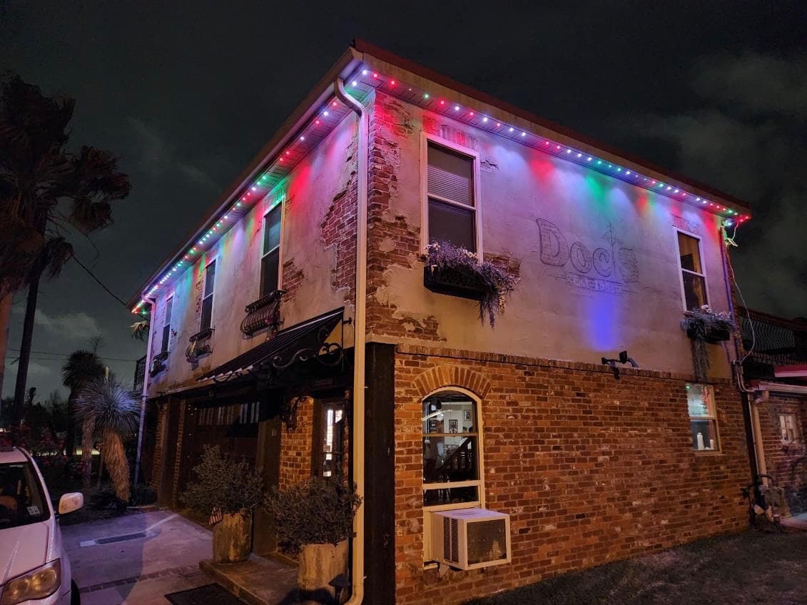 Permanent LED lighting on a historic Lake Charles commercial building with Christmas colours
