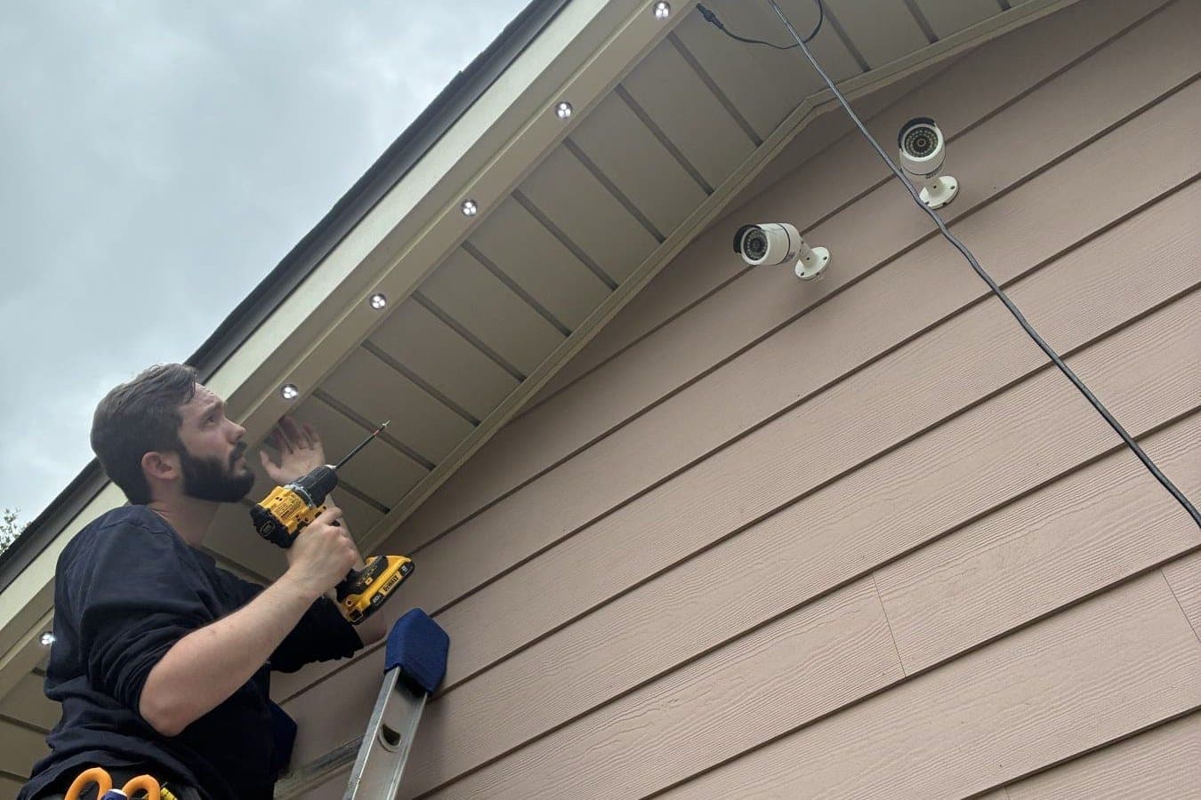 Number One Lights installer drilling the soffit for permanent lights