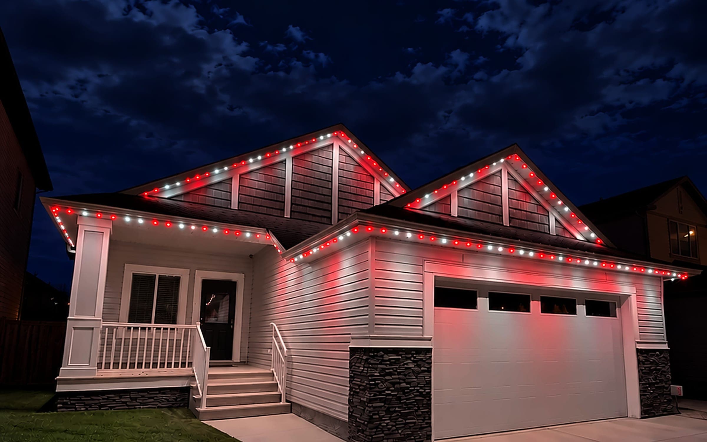 Home lit in bold team colours with permanent roofline lights
