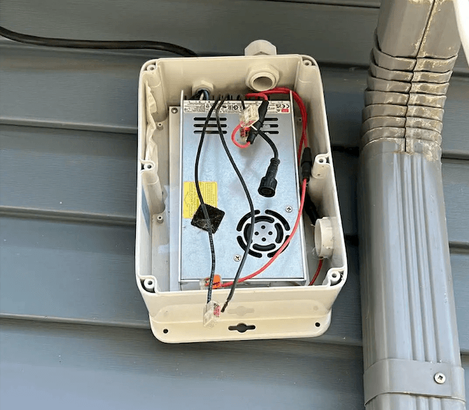 Failed inspection: uncertified control box with exposed wiring, active cooling fan, and no weather sealing