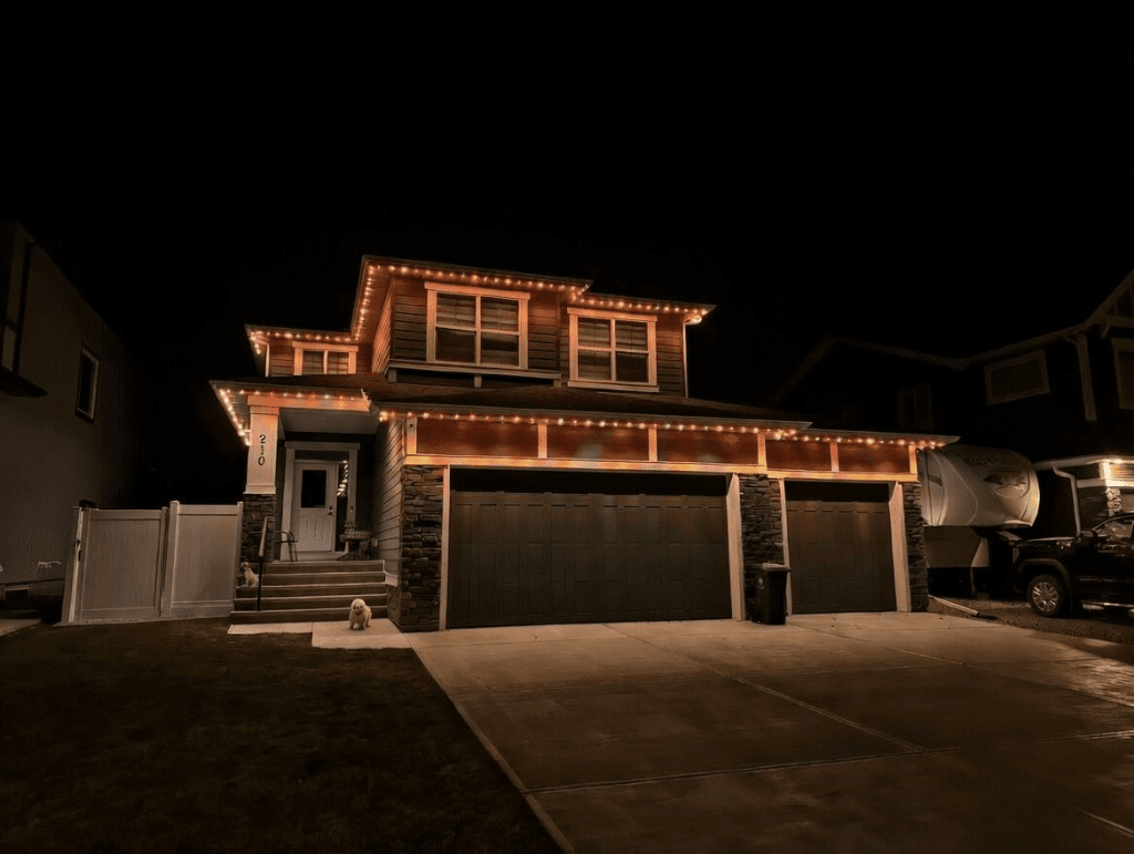 Home lit orange and purple for Halloween with permanent lights