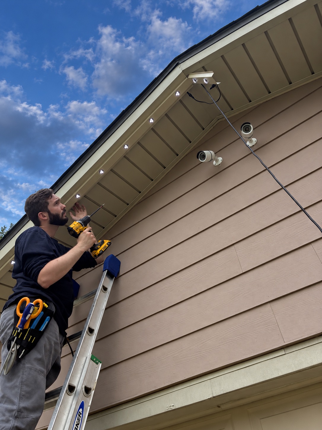 Installer fastening track to a soffit